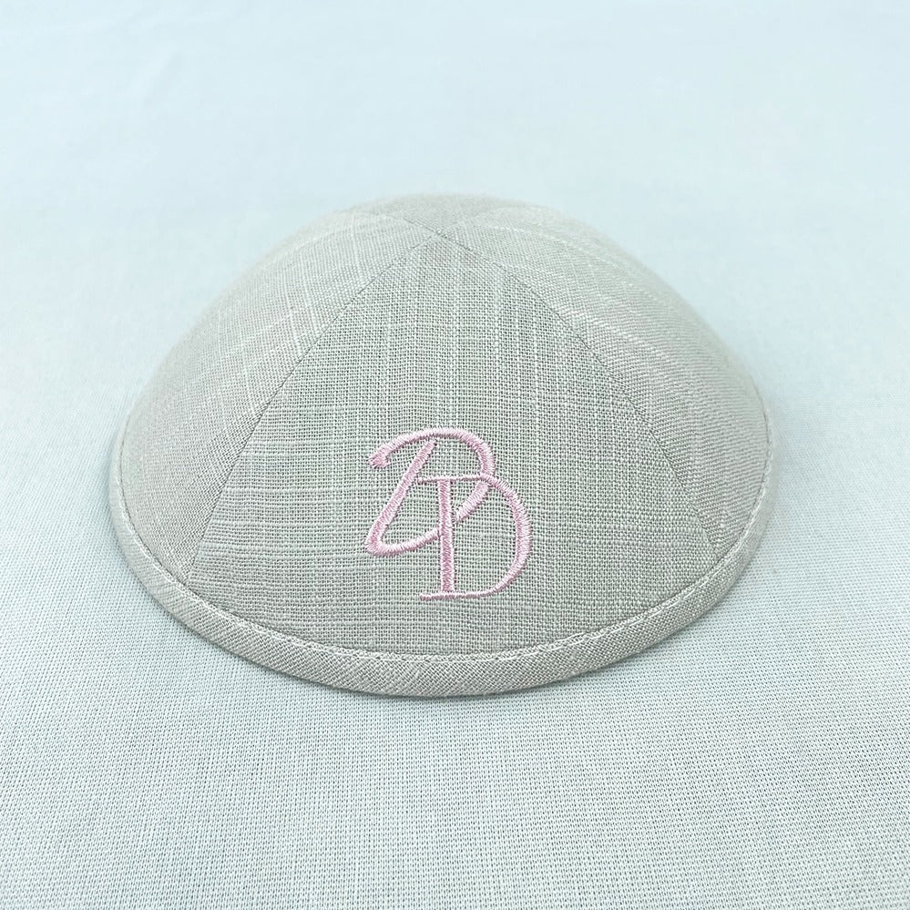 Pink embroidery on beige grey kippah outside cap