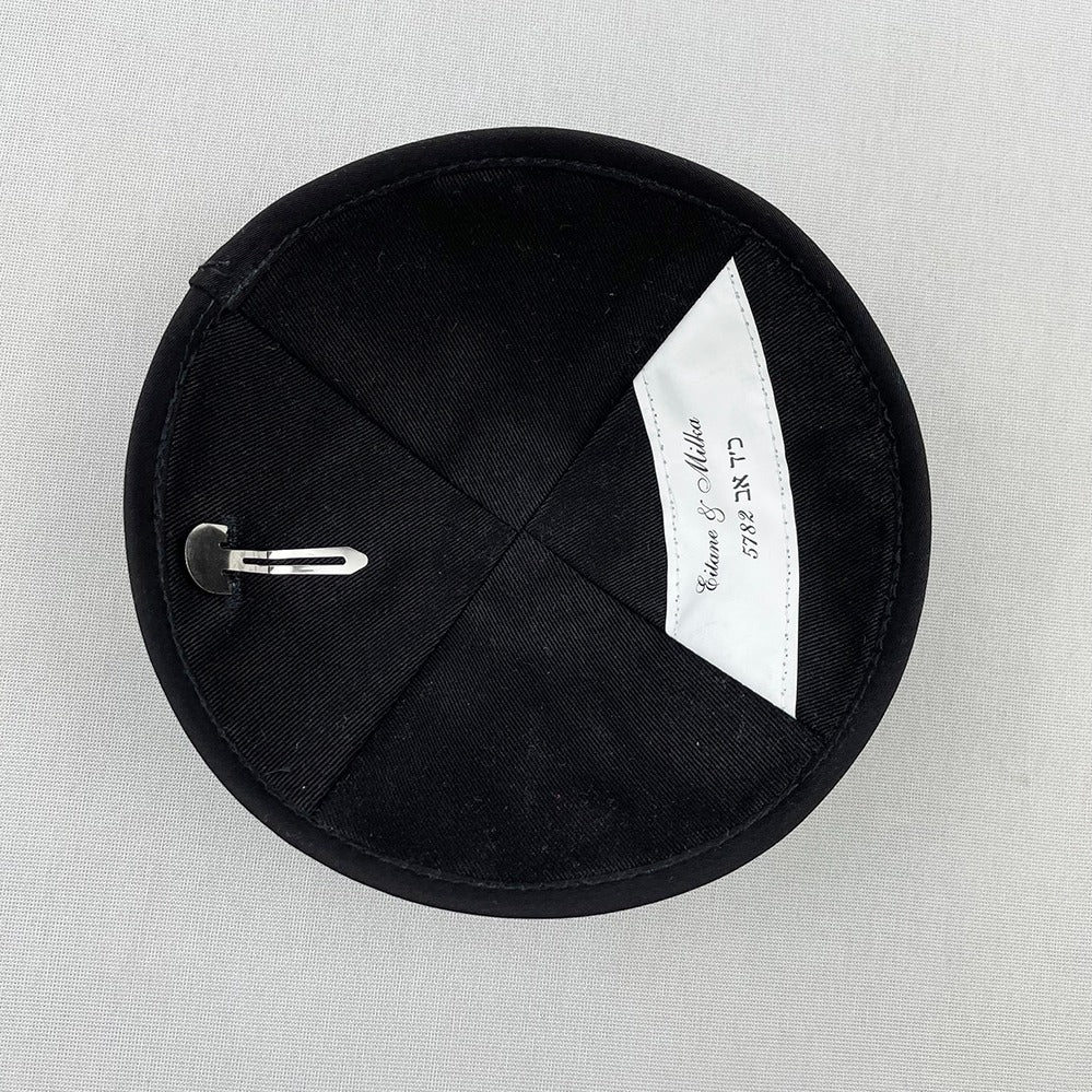 Inside of black yarmulke featuring personalised label and stitched in clip